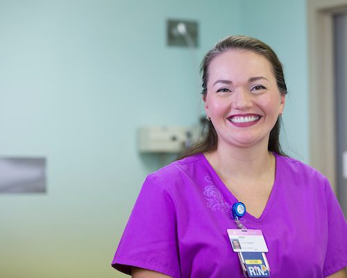 A nurse smiling in a hospital room